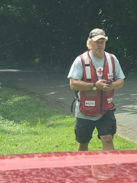 A person in a red cross vest