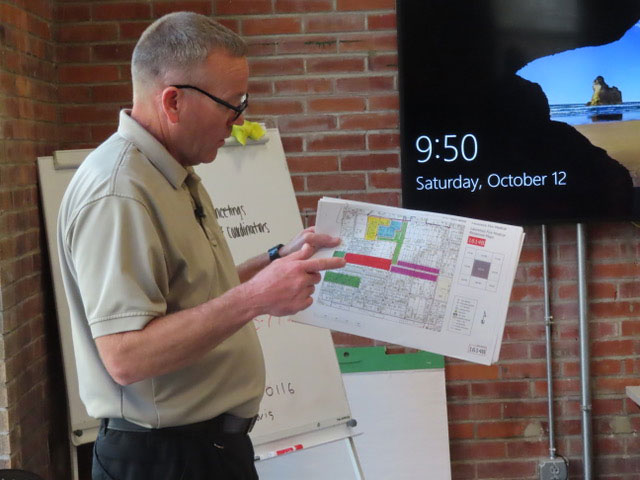 Chris King holding paper that maps out areas volunteers will visit.