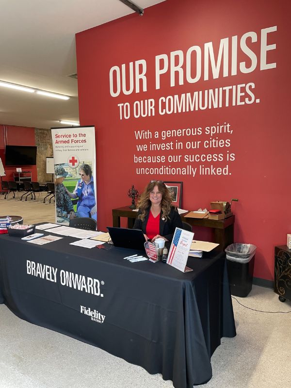 red crosser at armed forces information booth 