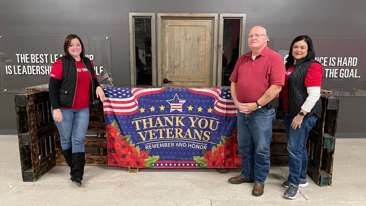 red crossers in front of a veterans thank you sign