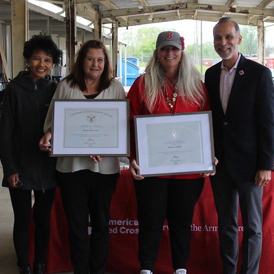 Red Cross volunteers holding certificates they received.