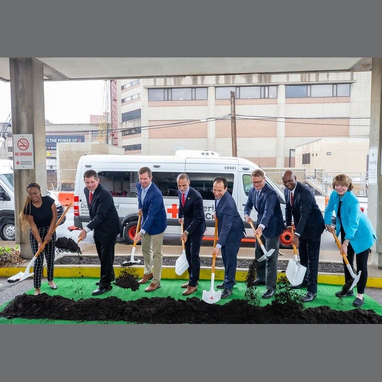 Red Cross workers breaking ground for new building.