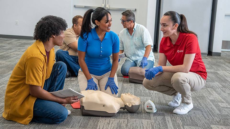 Red Cross instructor training First Aid and CPR in a class.