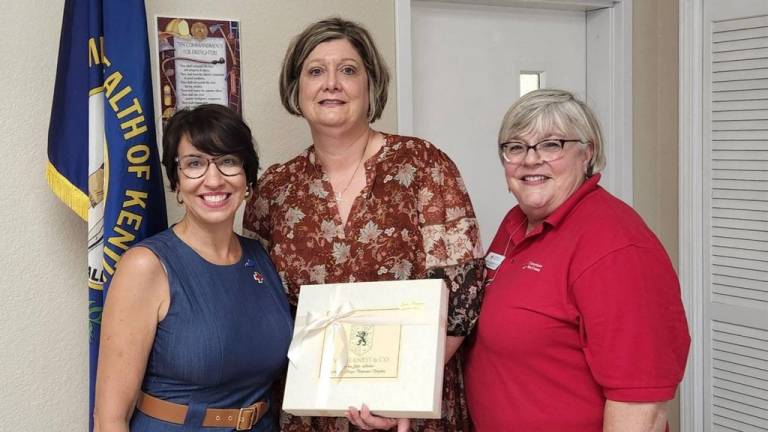 Three Red Crossers pose for a photo at an awards ceremony.