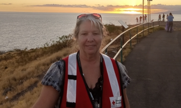 Joyce Caswell standing in front of a beach.