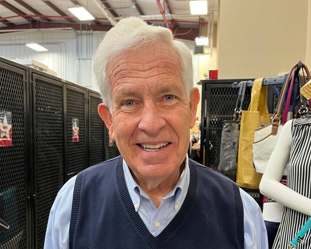 A Red Cross volunteer smiles at the camera.