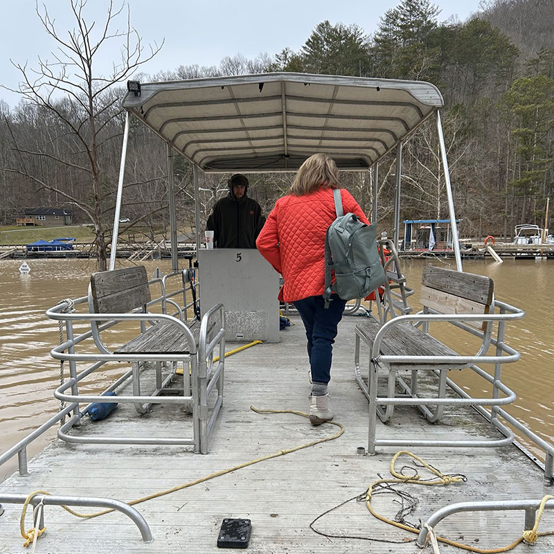 Lynne Washbish riding boat on a lake.