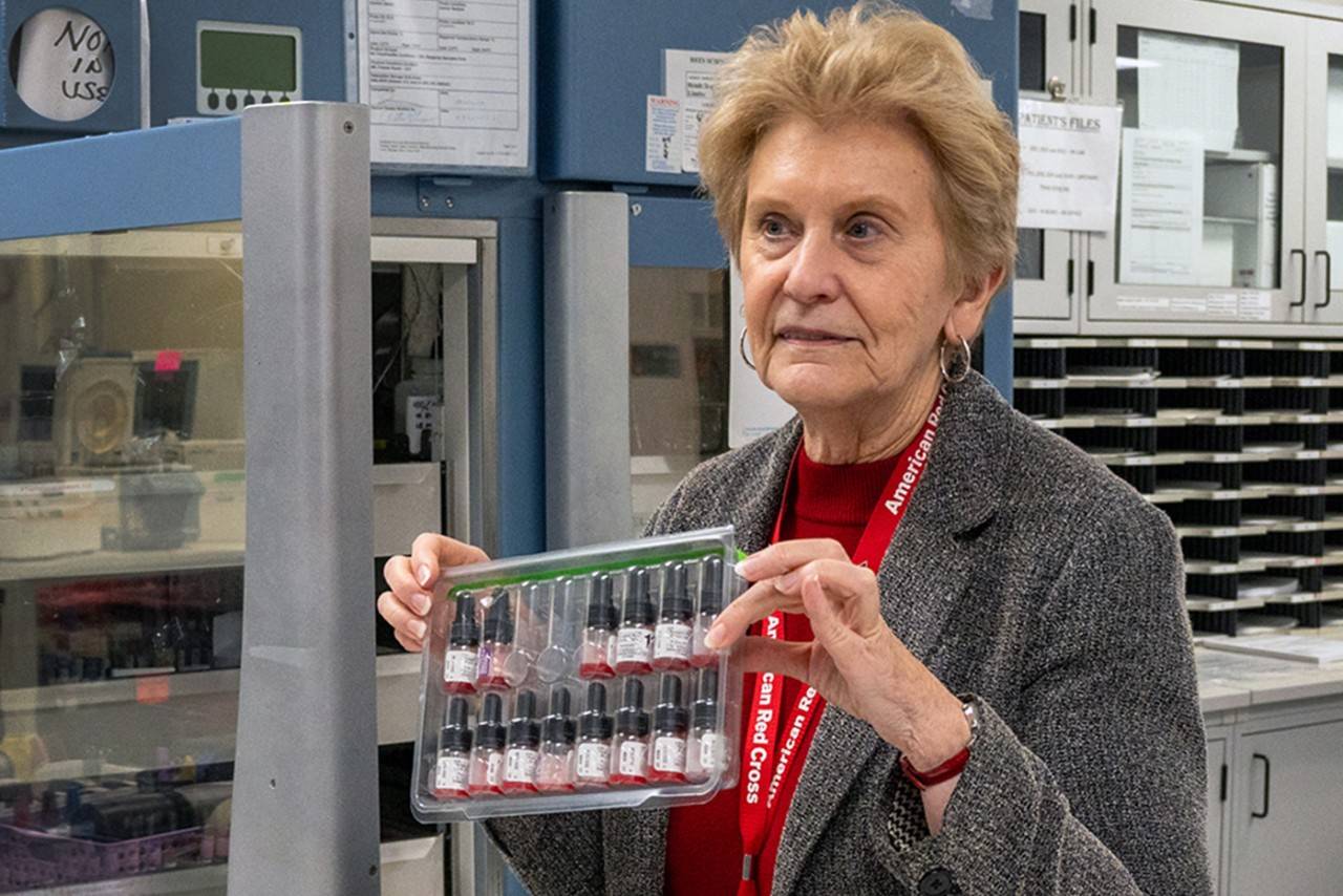 karen rodberg holds up blood specimens