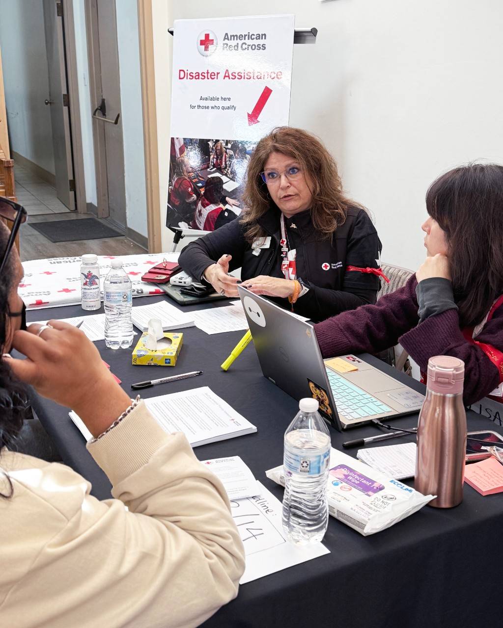 Volunteer Dee Chase guides someone through disaster recovery