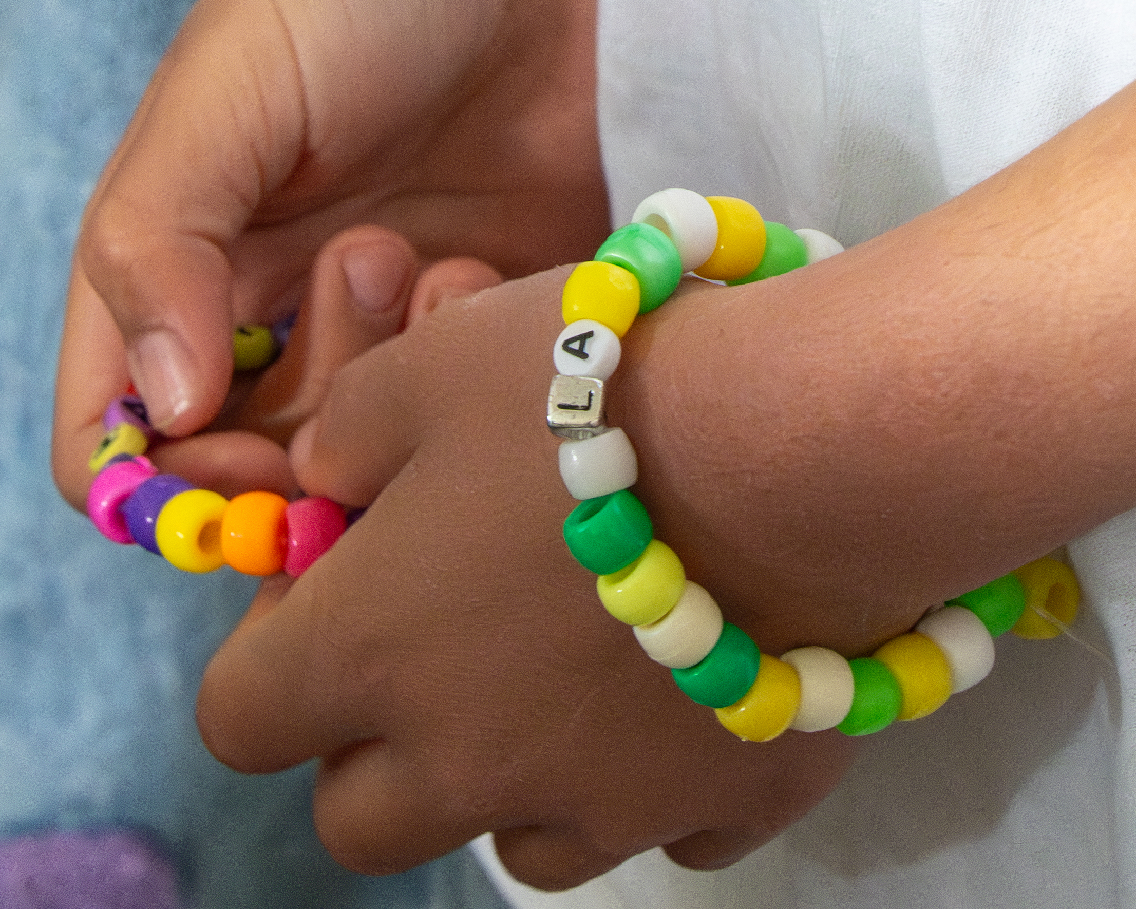 close up of a hand holding beads