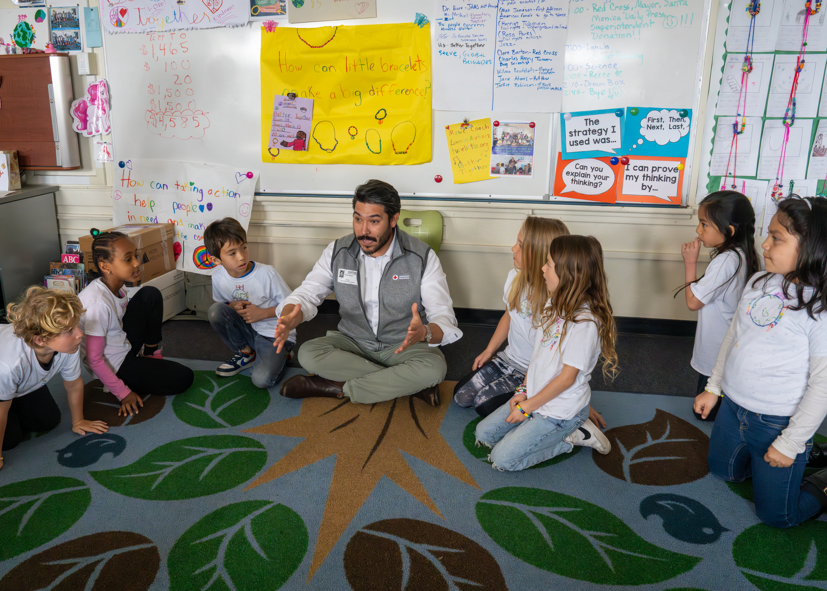 Volunteers answering questions from students