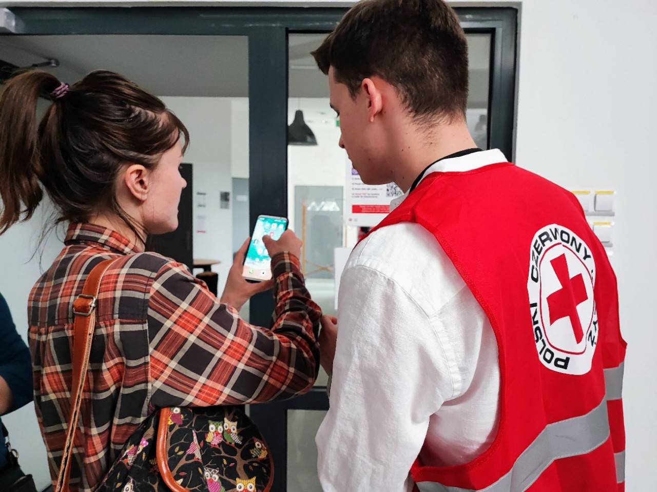May 13, 2022. Warsaw, Poland, Volunteers of Polish Red Cross and IFRC staff working in a Cash Assistance distribution center. Ukrainian refugees receive information and, after that, they are registered to the program. Friendly spaces for kids and exit surveys are being implemented as part of the project. Photo by Carla Guananga/IFRC