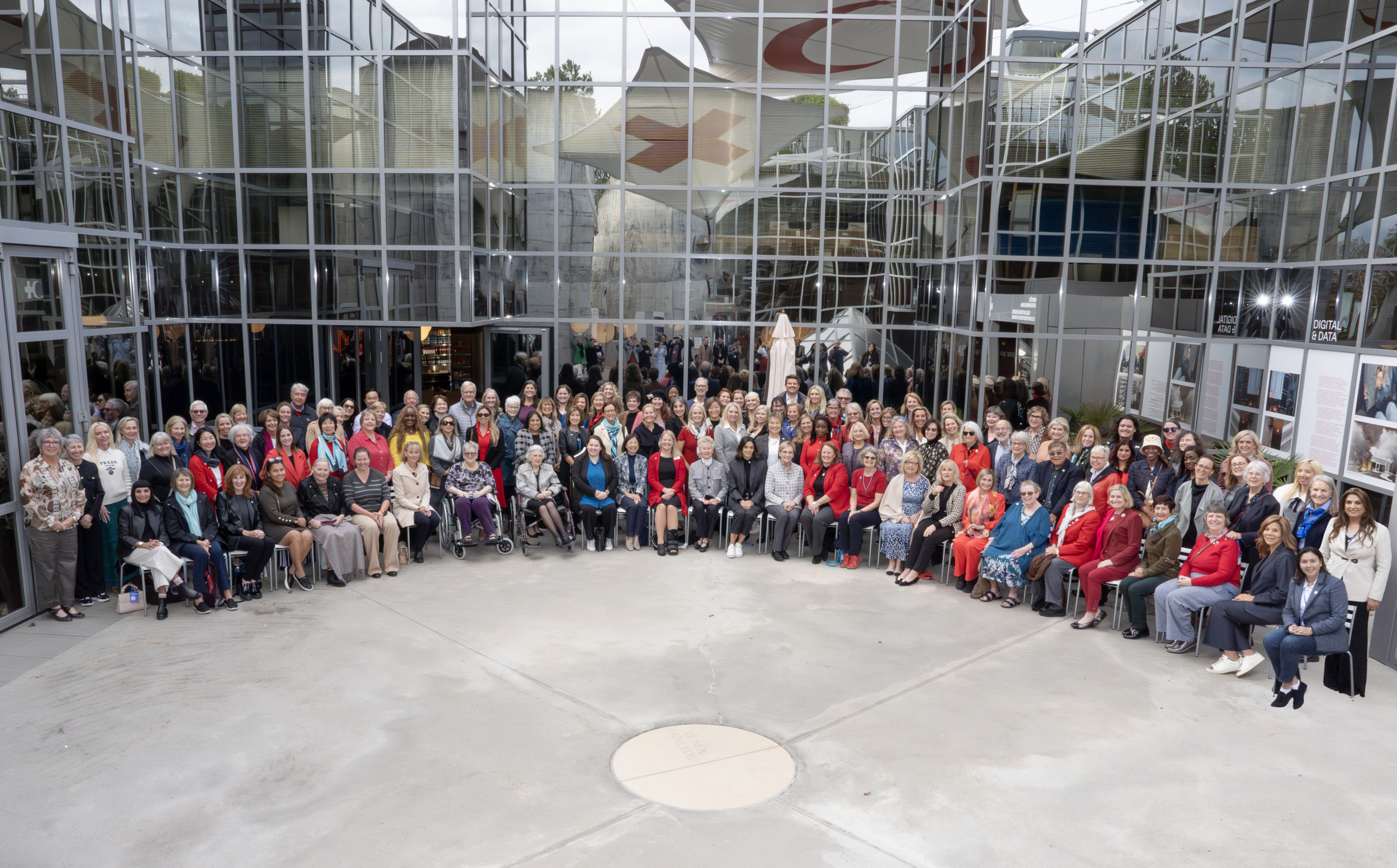 Large group of Tiffany Circle members in court yard of International Council Geneva Forum in Switzerland.