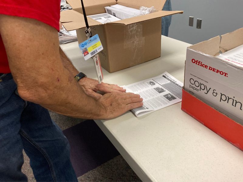 volunteer folding paper