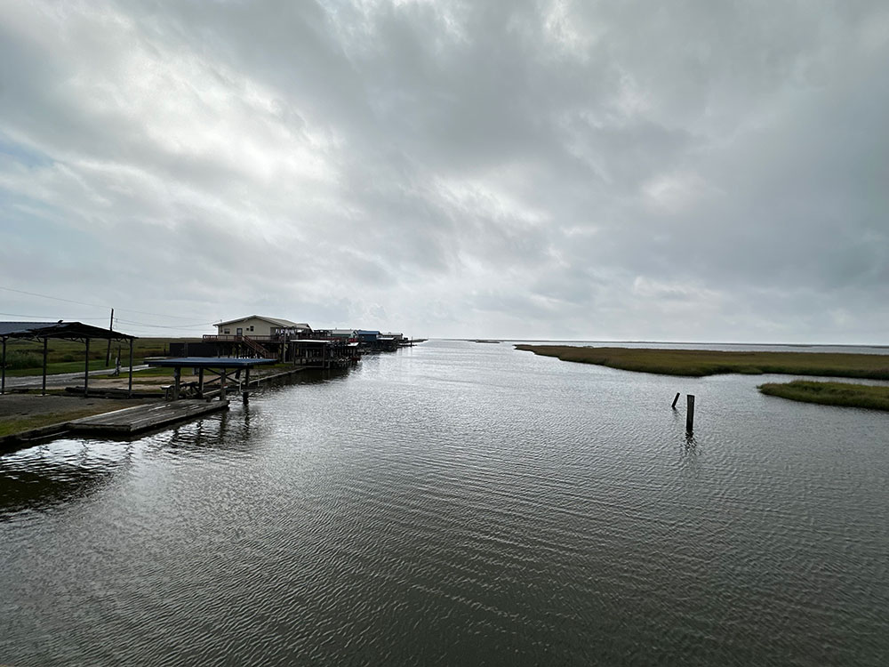 Calm body of water with residential houses on the banks.