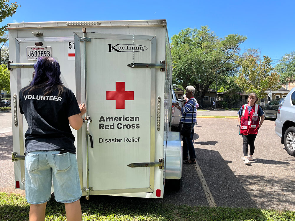 Red Cross volunteers opening the back of a Red Cross trailer.