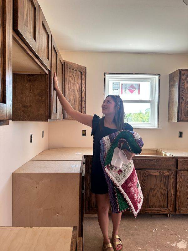 person viewing new home cabinets in kitchen