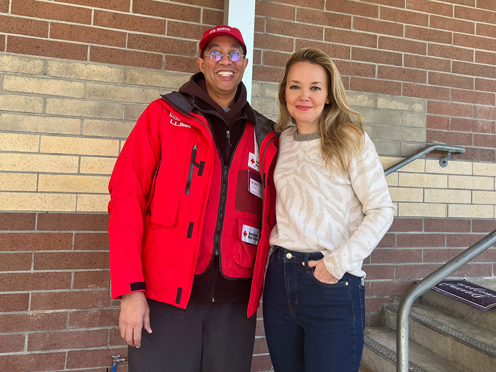 two Red Cross volunteers smile for picture.