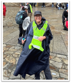 ANA GALLAGHER​ outside in a raincoat.