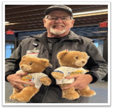 BILL BOYER holding two stuffed animal bears.