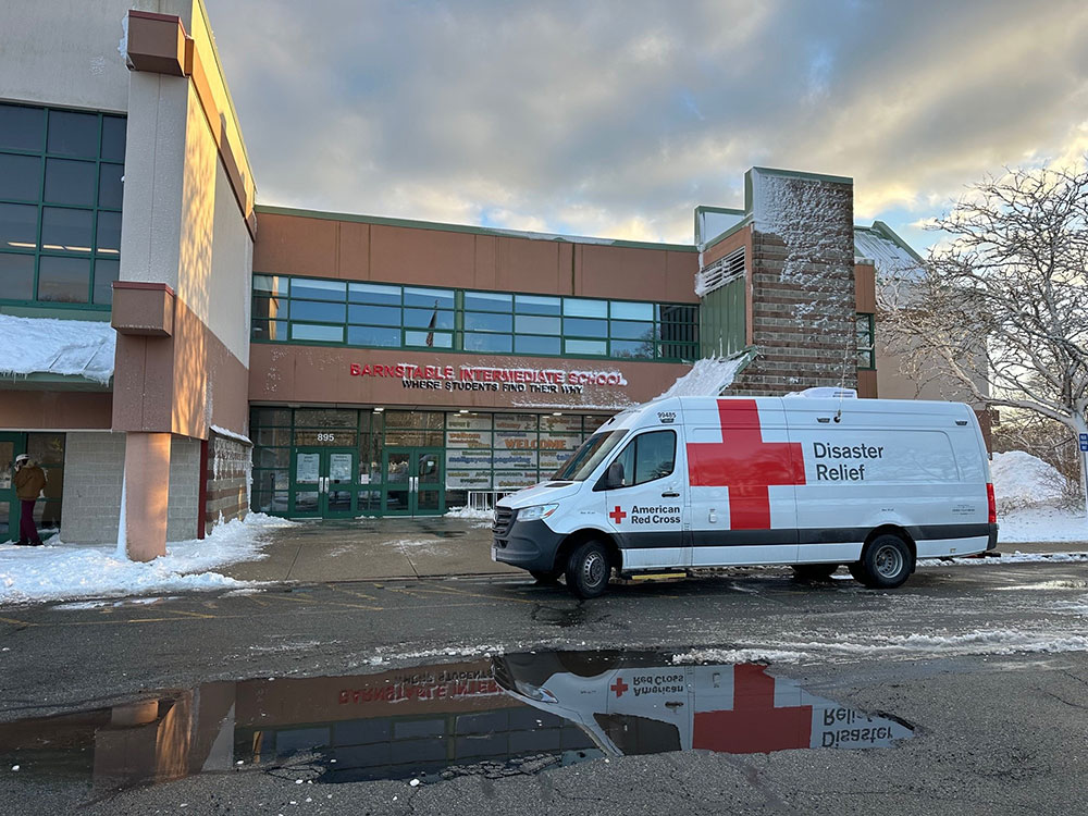 Man operates snow blower at emergency shelter.