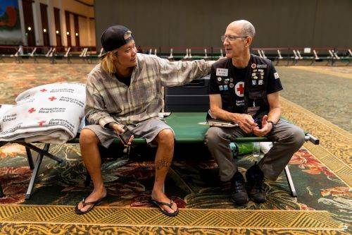 red cross client placing hand on rich byam's shoulder