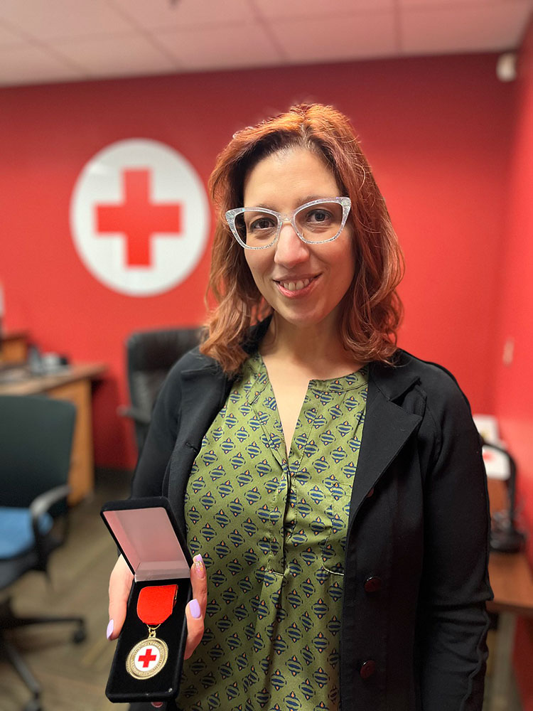 Yvonne Armando displaying her Certificate of Merit.