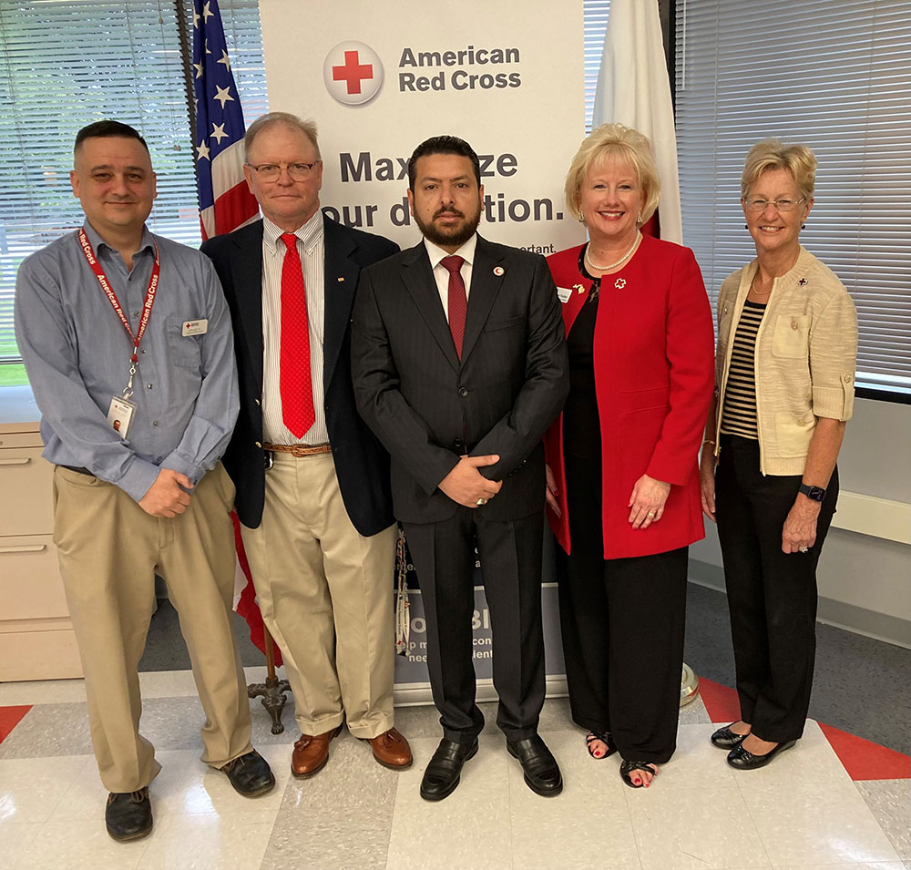 Five people in business clothes at Detroit Red Cross headquarters.