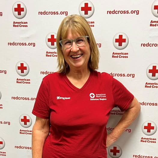 Mary Jane Westra, wearing a Red Cross shirt, at a Red Cross of Minnesota and the Dakotas Volunteer Recognition event.