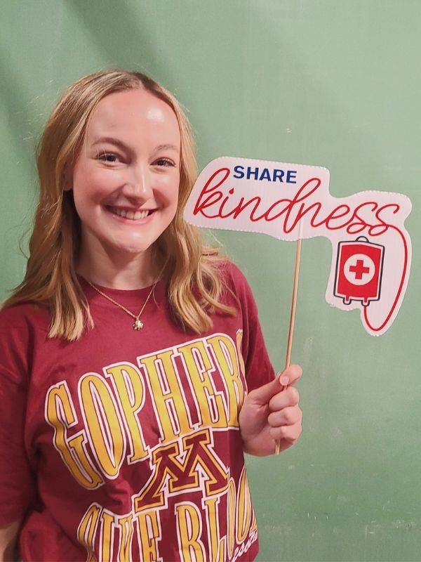 madelyn holding signage for her last chemo treatment