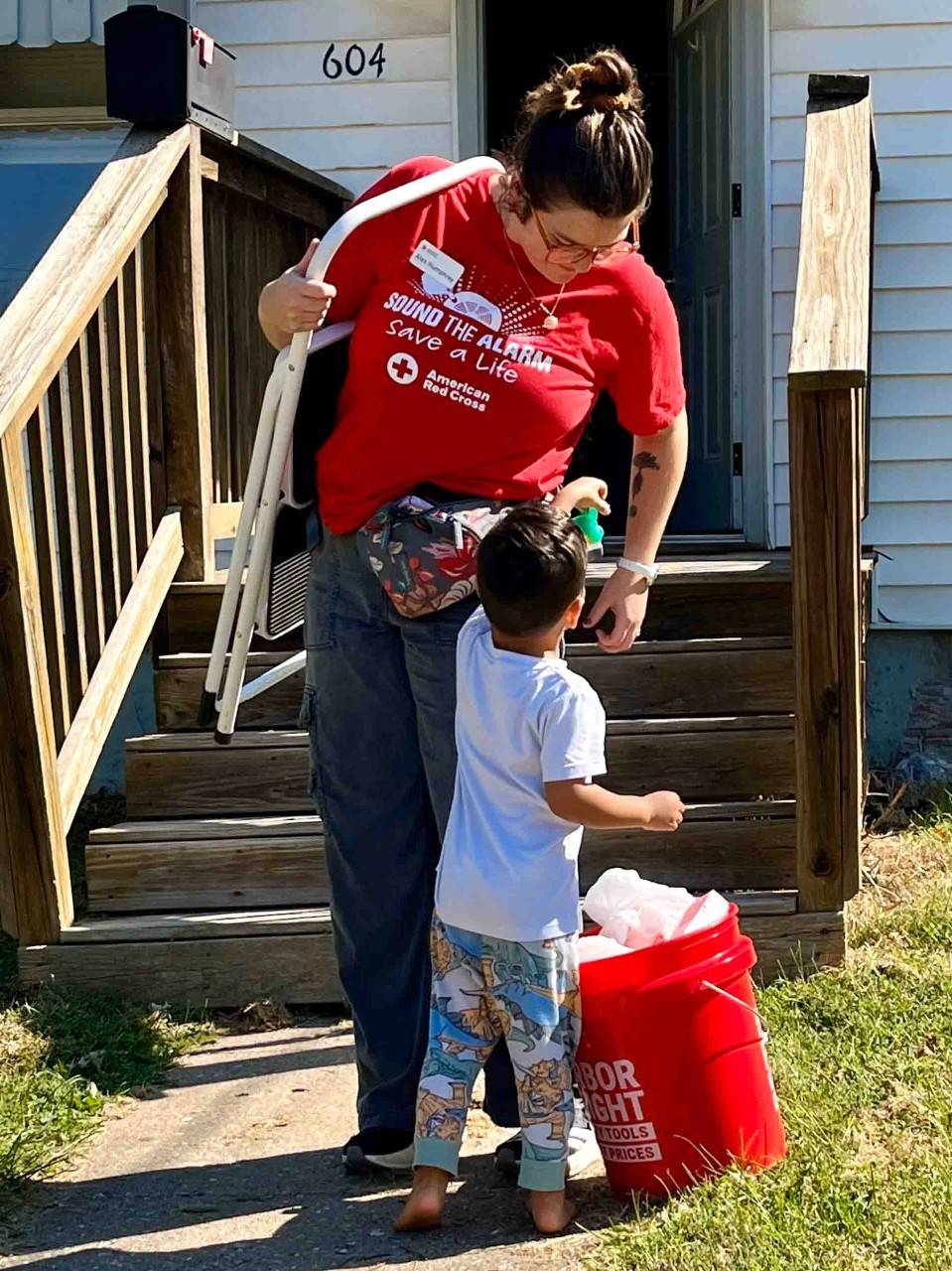 Volunteer Alex Humphrey carries a ladder.
