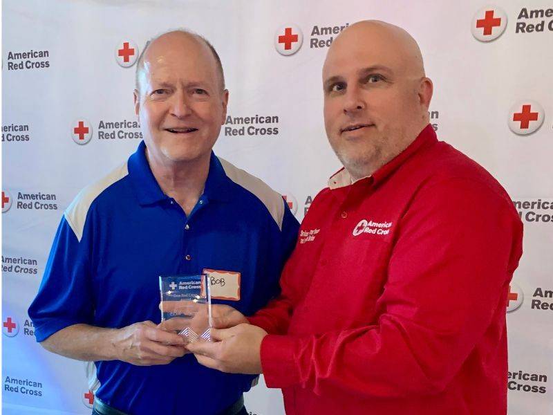 bob hergert and jason ramlow holding award