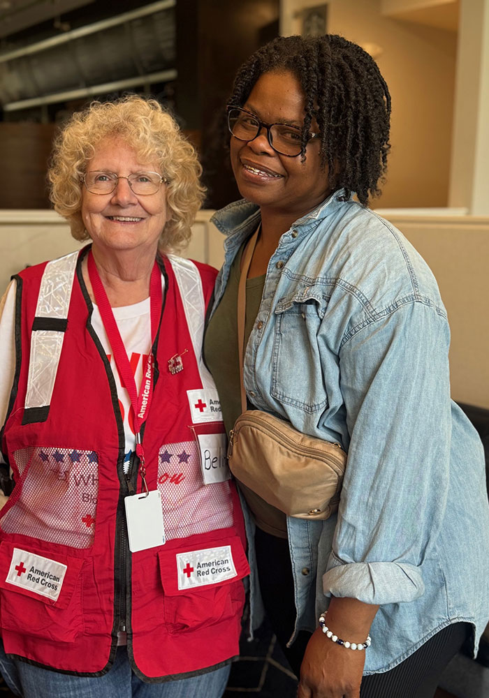 Chaunta Davis-Gibbs and Red Cross volunteer pose for a picture.