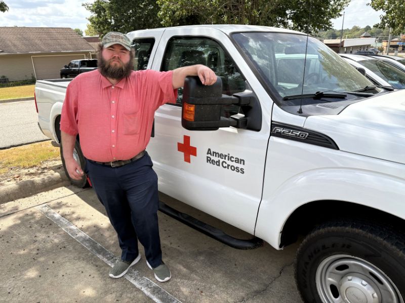 volunteer jody williams standing next to red cross truck
