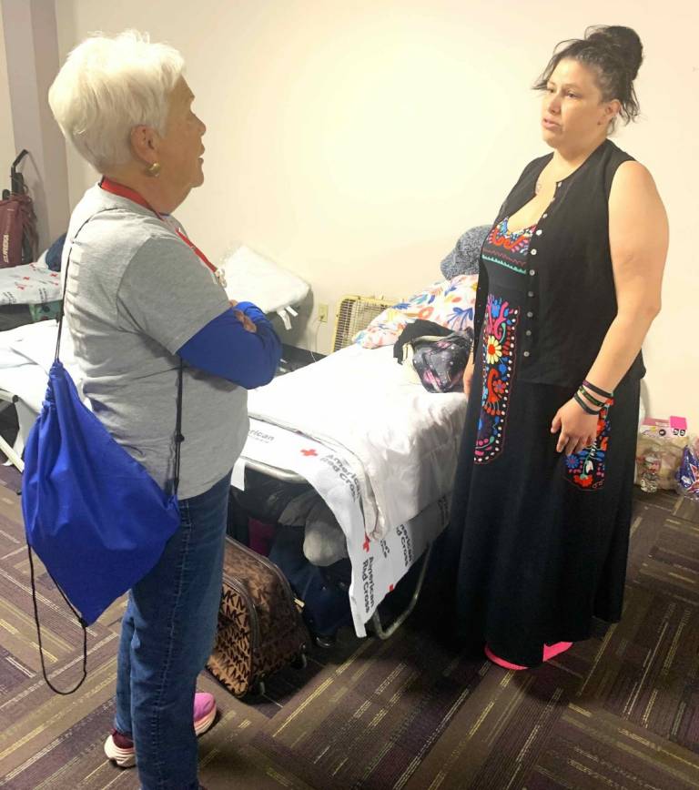 Volunteer Joanne Fehlin talks to Tiffany Chandler