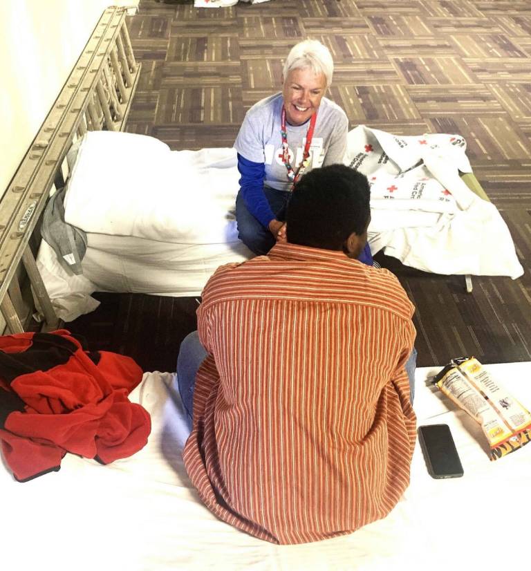 Volunteer Joanne Fehling talks to a resident