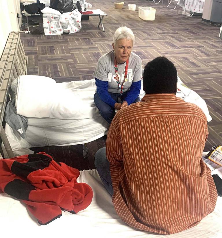 Volunteer Joanne Fehling talks to a resident