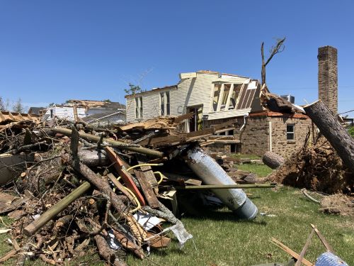 image of tree fallen on top of house
