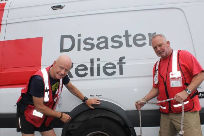 Red Cross volunteers, Federico Materazzi and Bryan Ward inspecting an emergency response vehicle.