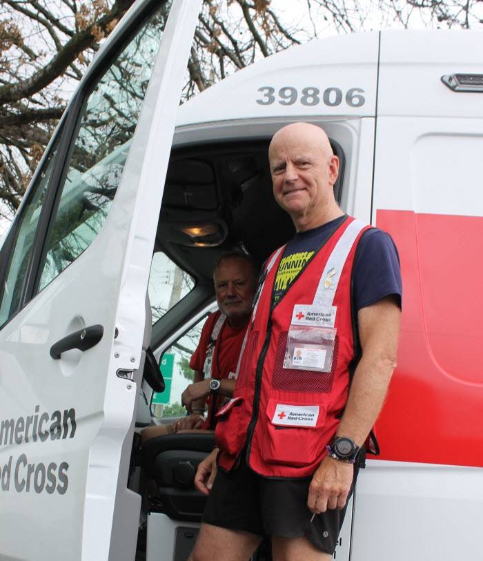 Red Cross volunteers, Federico Materazzi and Bryan Ward getting into an emergency response vehicle.