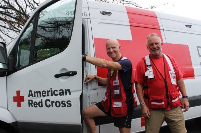 Red Cross volunteers, Federico Materazzi and Bryan Ward getting into an emergency response vehicle.