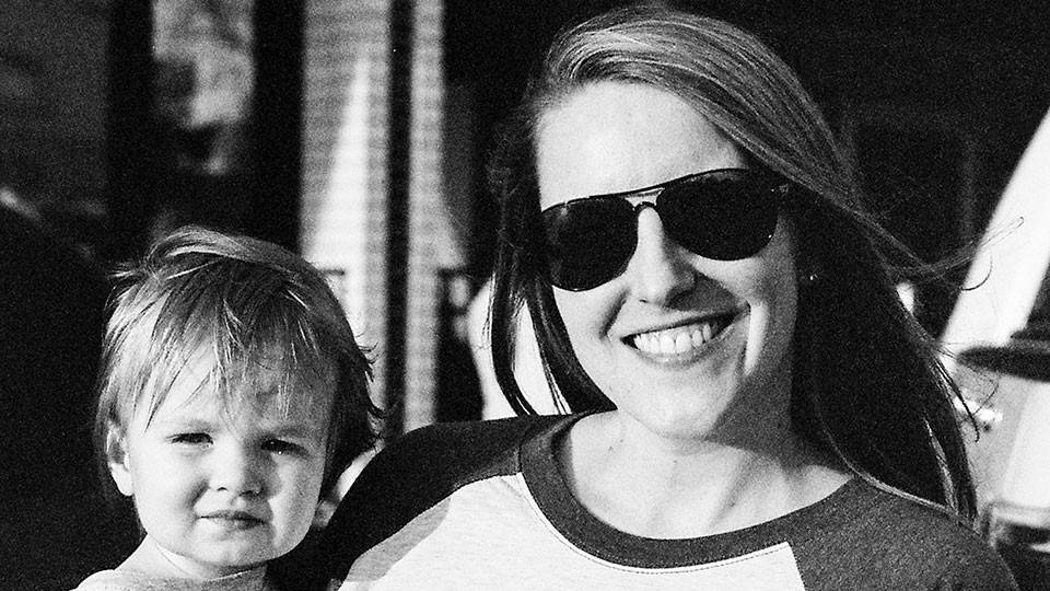Meghan Jolliffe wearing sunglasses and holding her 8-year-old son, Sully.