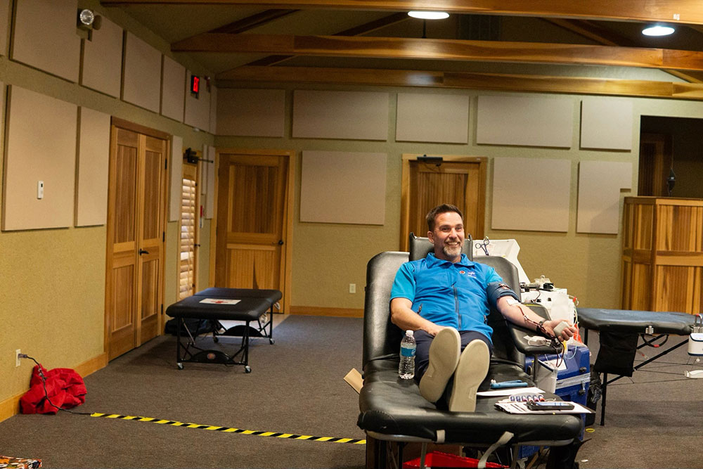 Man giving blood in chair