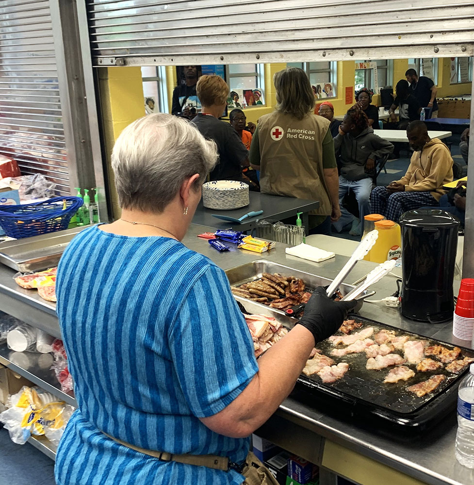 Joy of Pancakes team member working in the kitchen of a Red Cross shelter.