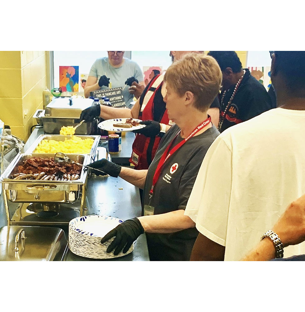Residents at a Red Cross shelter line up to be served breakfast.