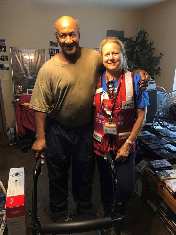 ricky and red cross volunteer smiling