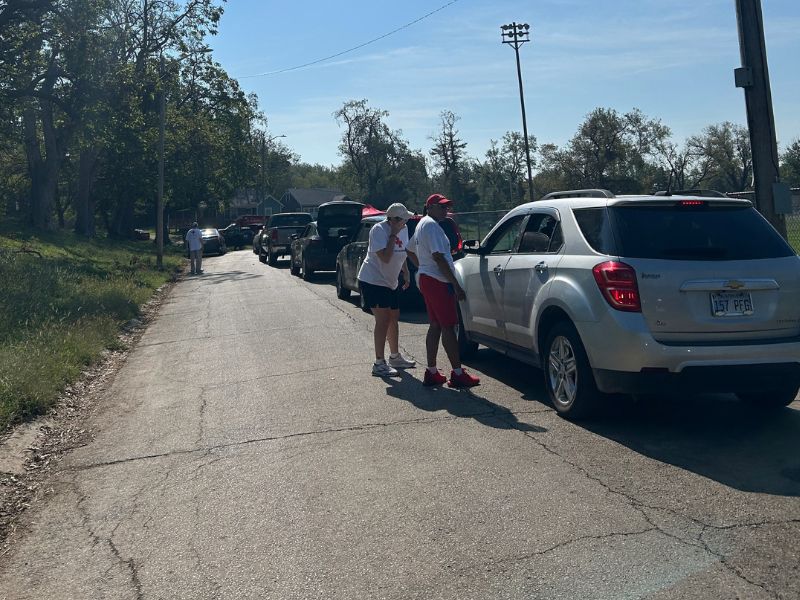 volunteers speaking with people in vehicles