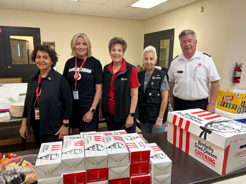 group of redcrossers in front of packed lunches