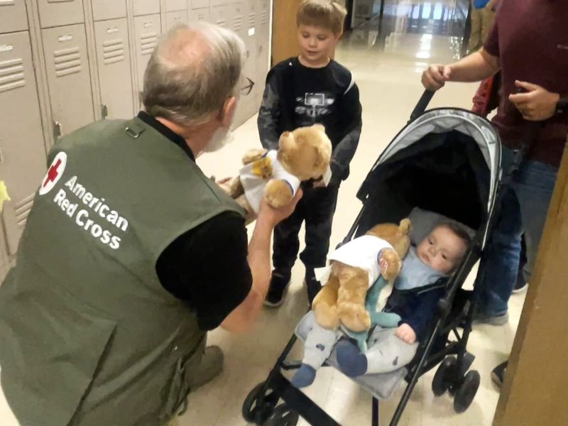 volunteer comforting young shelter residents.