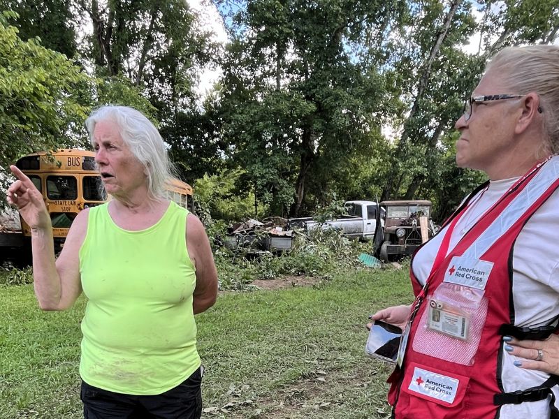 woman spreaking with disaster volunteer outside